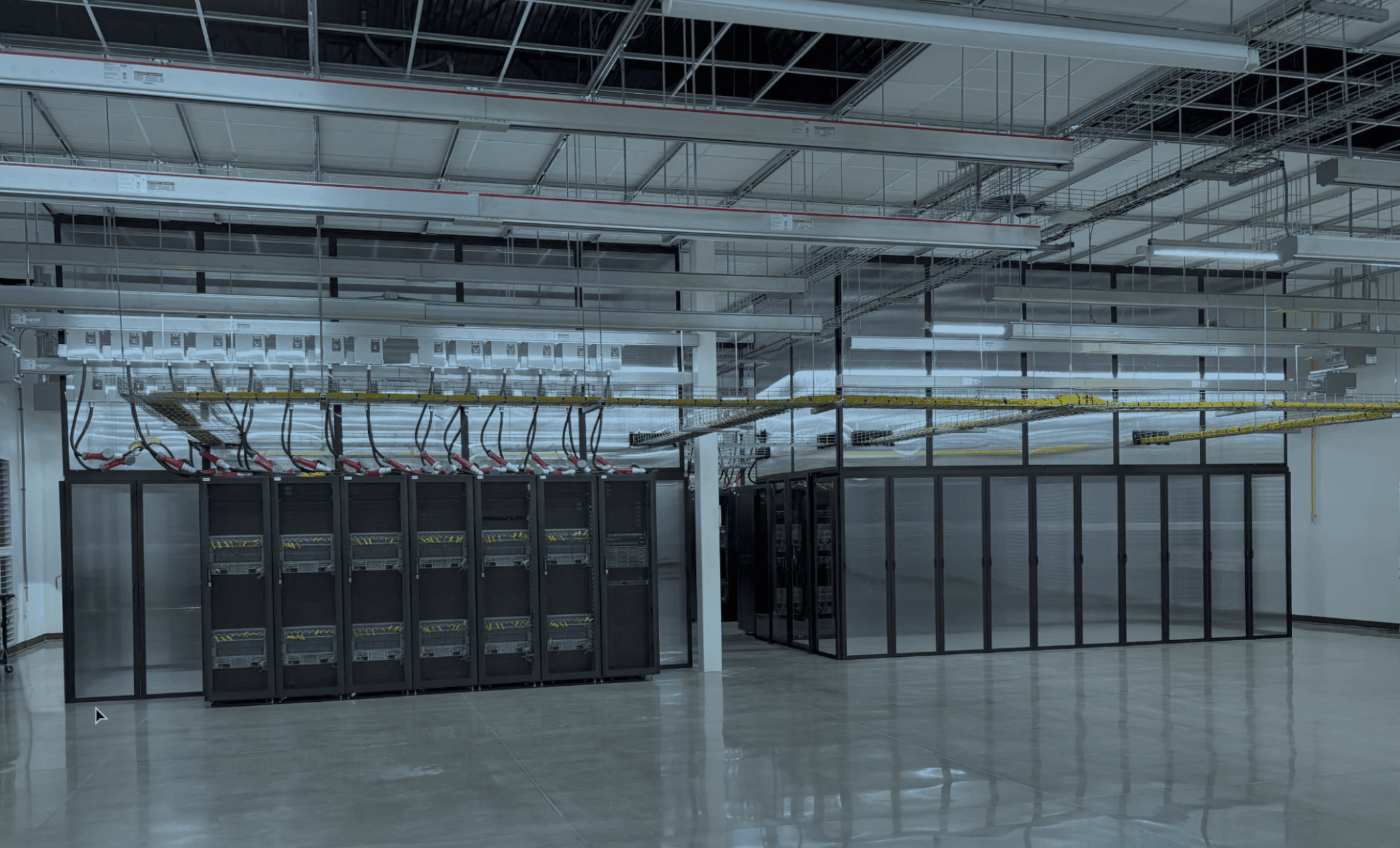 Data hall with server cabinets and overhead power and cable infrastructure